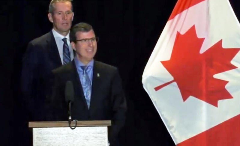 Premier Brian Pallister and Civil Service Minister Reg Helwer by Canadian flag